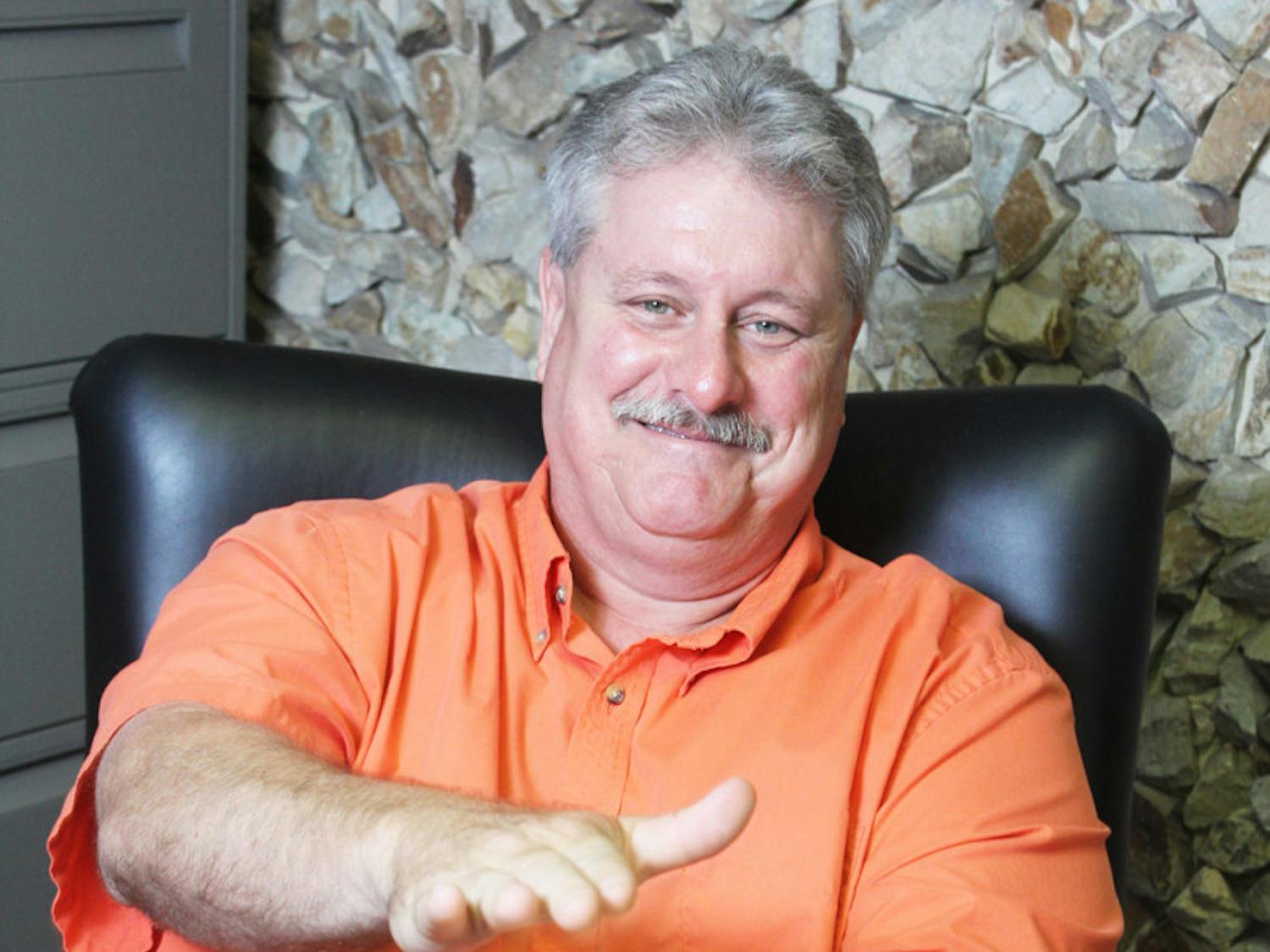 John Martin does a Gator Chomp at his campaign headquarters Monday. Martin was part of the Hawthorne City Commission for 13 years.