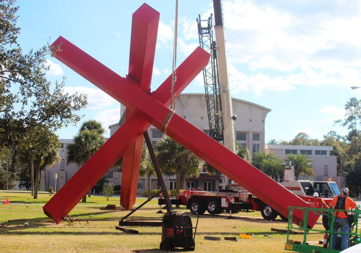 Sculptor John Raymond Henry installs “Big Max,” a 33-foot-tall sculpture that was given to the Samuel P. Harn Museum of Art on Tuesday afternoon. The sculpture is named after Henry’s grandson.