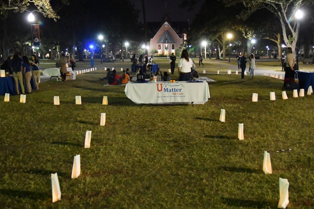 About 20 people attend the beginning of the candle lighting held by the Student Government Health Affairs Cabinet to raise awareness for eating disorders on Thursday evening on the Plaza of the Americas.