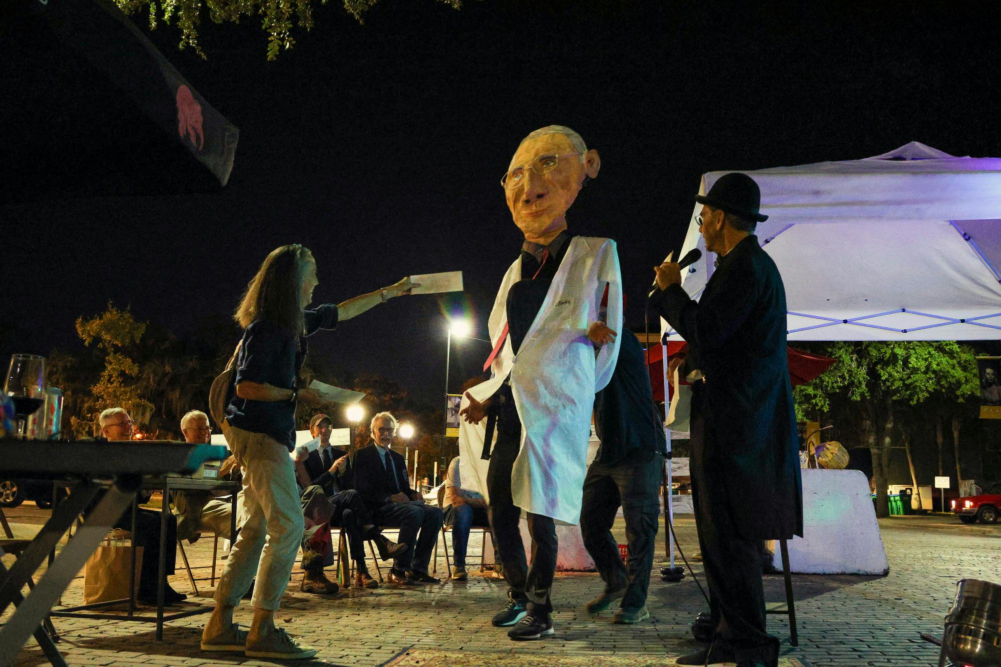 Doug Mackey, shown here as “Nine Foot Fauci,&quot; accepts his prize during the Dr. Fauci Lookalike Contest  Wednesday Oct, 26, 2022