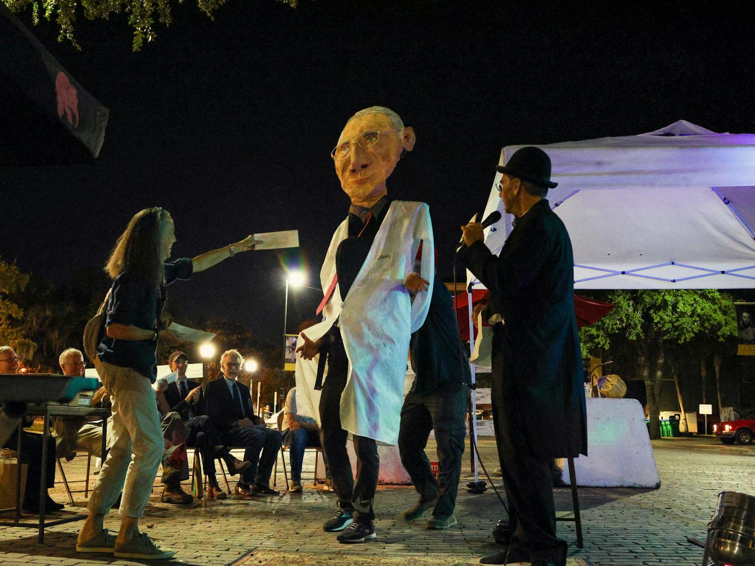 Doug Mackey, shown here as “Nine Foot Fauci," accepts his prize during the Dr. Fauci Lookalike Contest Wednesday Oct, 26, 2022