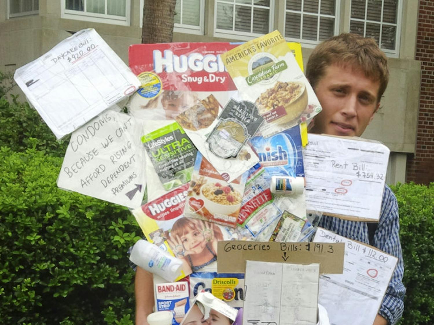 Outside Tigert Hall, the Co-President of Graduate Assistant United Alec Dunnin prepares to deliver a basket filled with items graduate students can’t afford because of university fees on Nov. 19, 2015. The 27-year-old UF political science PhD student said GAU wanted to make the $720 fee real and visible in a creative way.