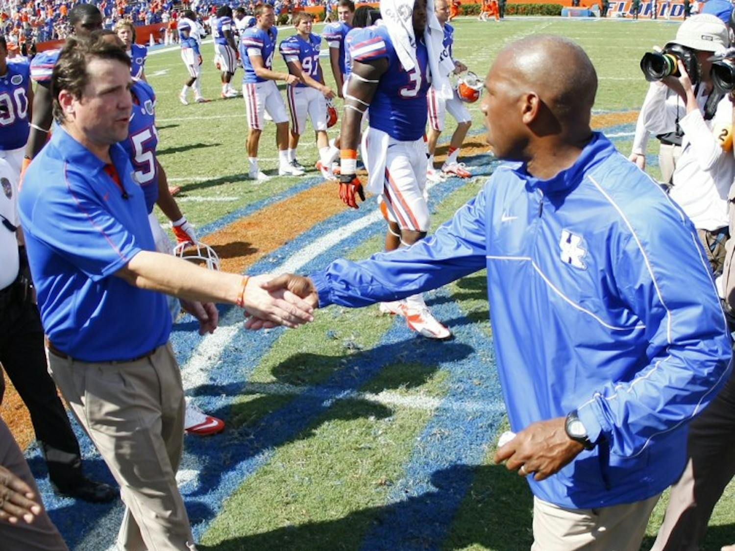 Gators coach Will Muschamp shakes hands with Kentucky coach Joker Phillips after the game at Ben Hill Griffin Stadium on Saturday. Kentucky moved to 23-57 in conference play since 2002.
