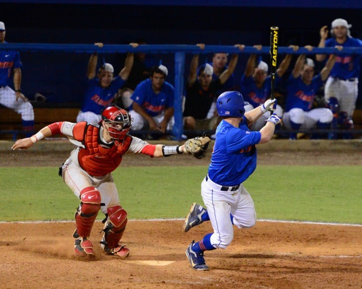 Nolan Fontana dodges Brandon Stephens' tag after a dropped third strike. Stephens' wild throw to first allowed Nolan Fontana to reach base and a run to score. The Gators defeated the Bulldogs 3-2.