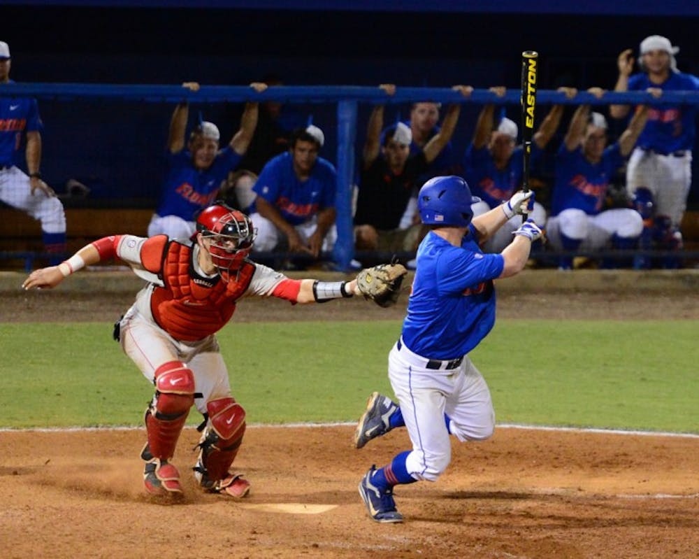 <p>Nolan Fontana dodges Brandon Stephens' tag after a dropped third strike. Stephens' wild throw to first allowed Nolan Fontana to reach base and a run to score. The Gators defeated the Bulldogs 3-2.</p>