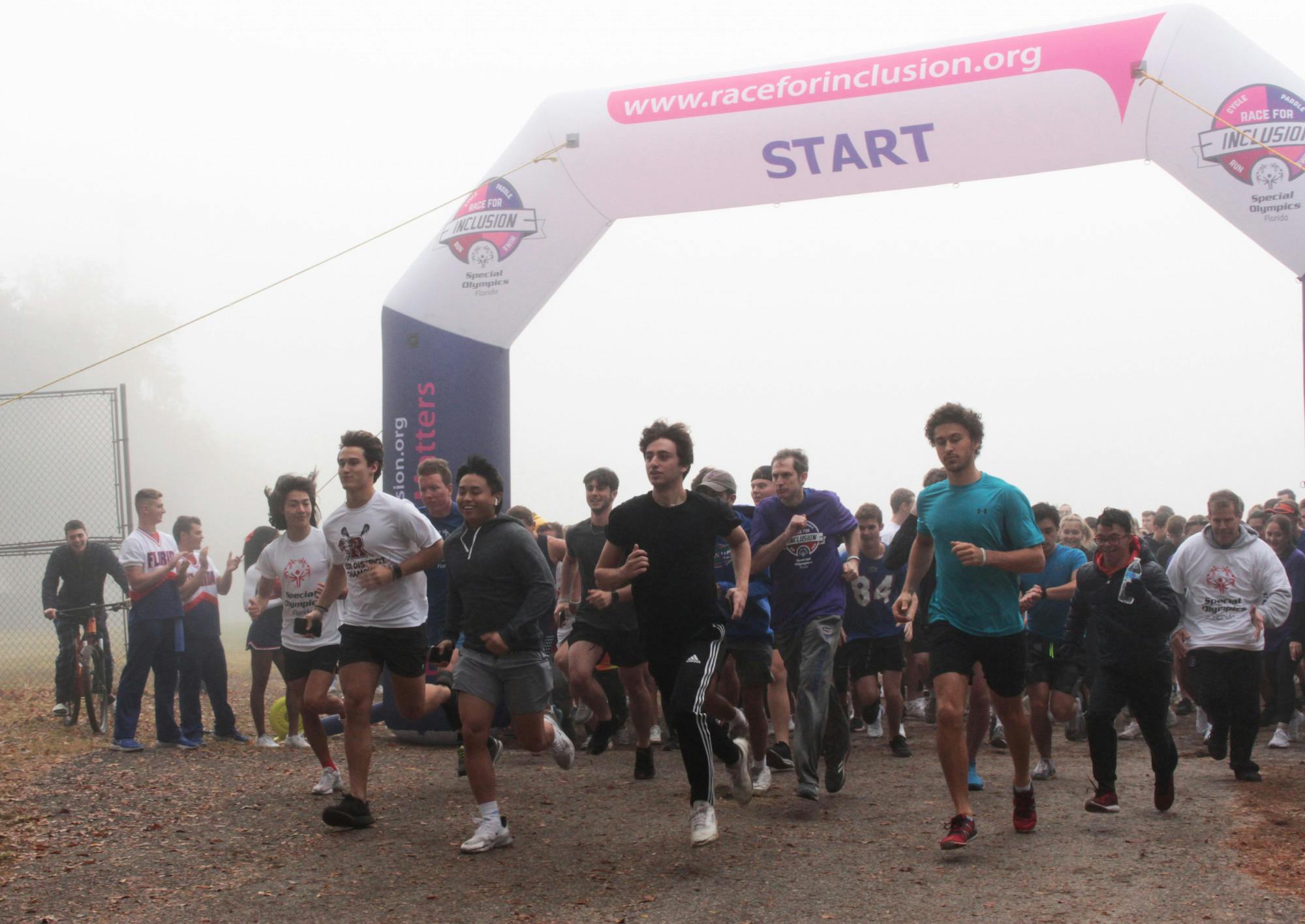 Participants start running during the Gainesville Race for Inclusion organized by Special Olympics Florida on Dec. 4, 2021. Nathan Grinalds came first in the race.