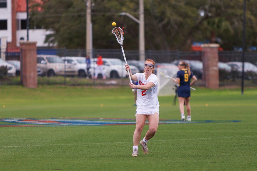 Florida midfielder Madison Waters throws the ball with her crosse during the Gators' 17-8 victory against the Michigan Wolverines, Sunday, Feb. 12, 2023. 