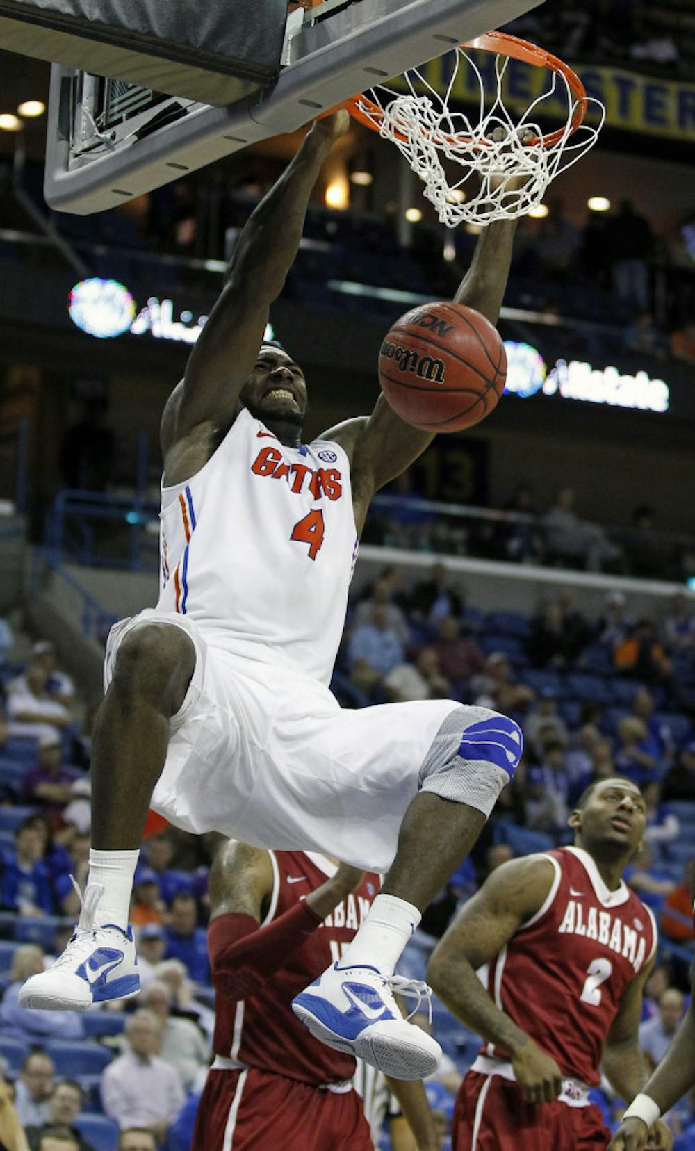 <p>Florida's Patric Young (4) dunks the ball as Alabama guard Charles Hankerson Jr. (2) watches during the second half of the Gators' 66-63 win in the SEC Tournament on Friday.</p>