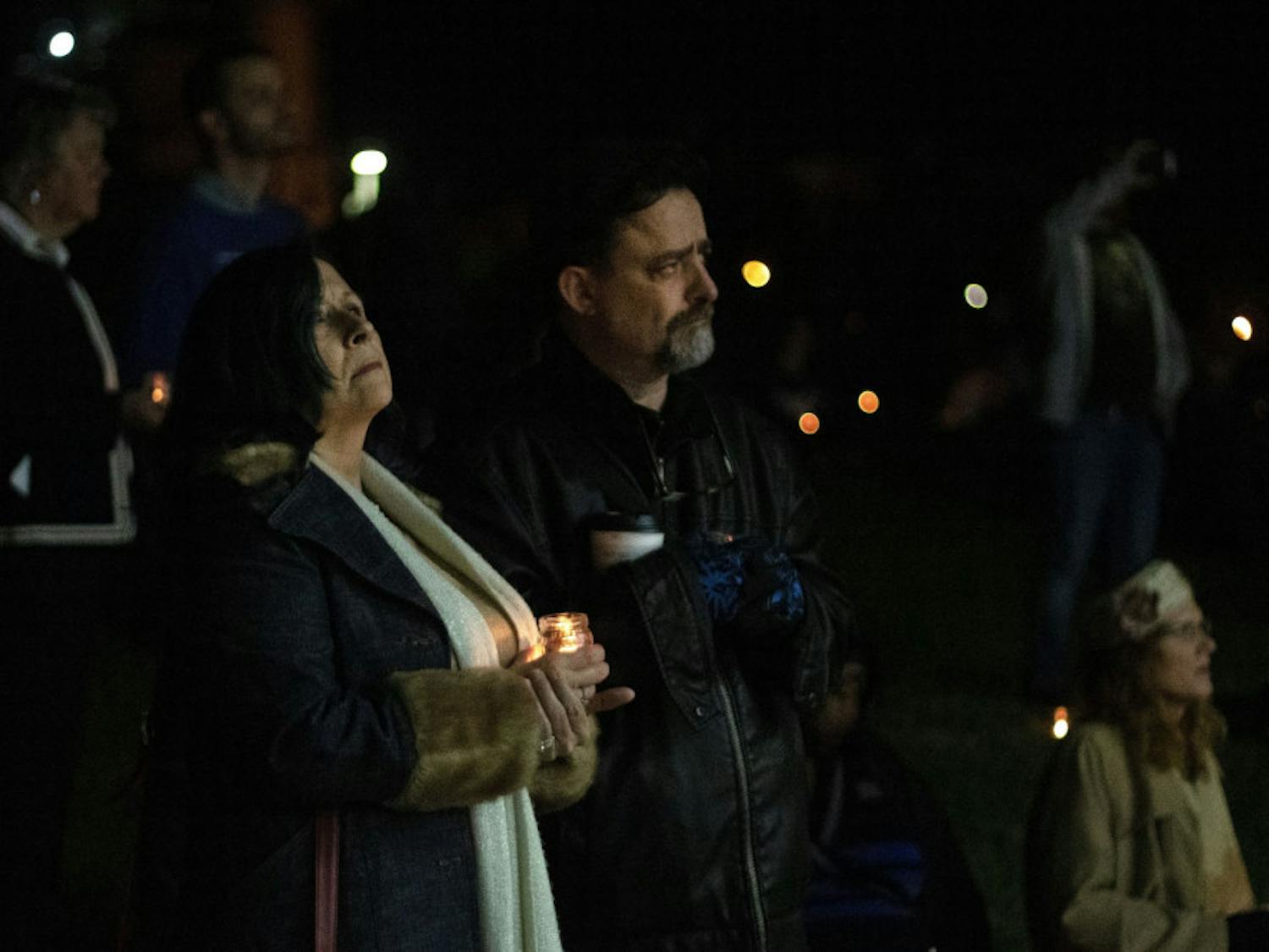 Carmen King, 55, and Christopher King, 58, stand in solidarity Wednesday evening as the names of transgender people who have lost their lives to transphobic violence are read aloud during the Transgender Day of Remembrance at Depot Park. The King’s said they have a transgender daughter who lives in Holland.