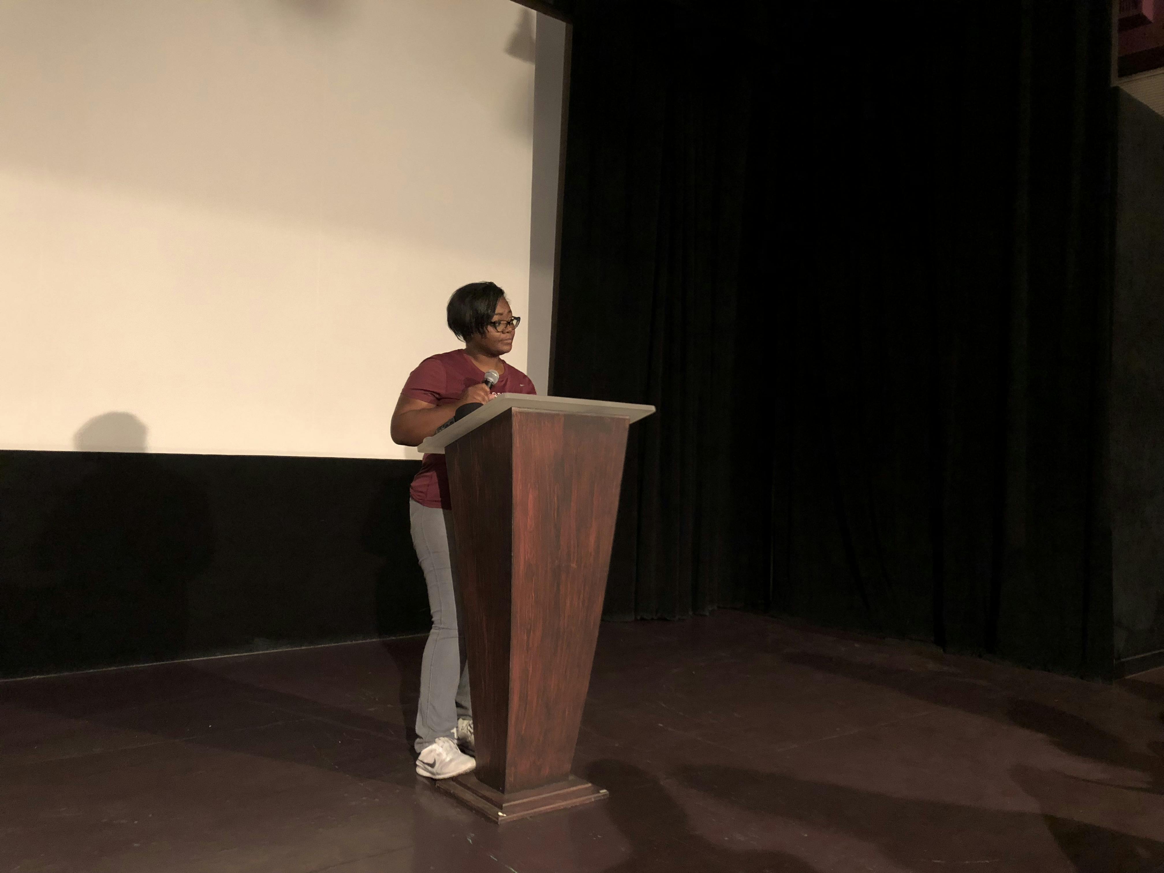 Chanae Jackson-Baker is speaking to a crowd of about 70 people at the Hippodrome Theatre on Monday evening about the inequity in Alachua County schools. 