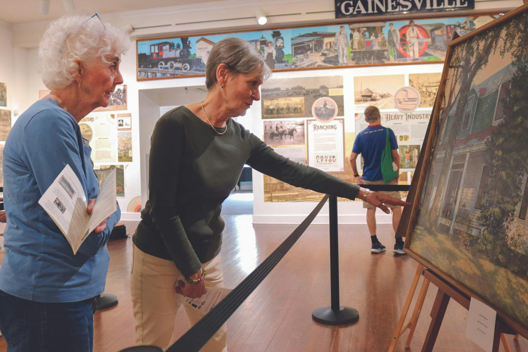 Gainesville resident Beth Kent and retired Director of the Harn Museum Rebecca Nagy look at a piece displayed during the Art from the Archives one-day exhibit at the Matheson History Museum, Saturday, Nov. 15, 2025.