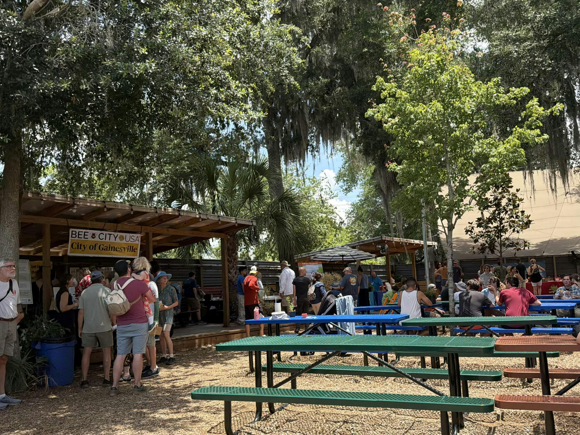 Pollinator Palooza attendees talk to educational tables and drink beer at First Magnitude. 