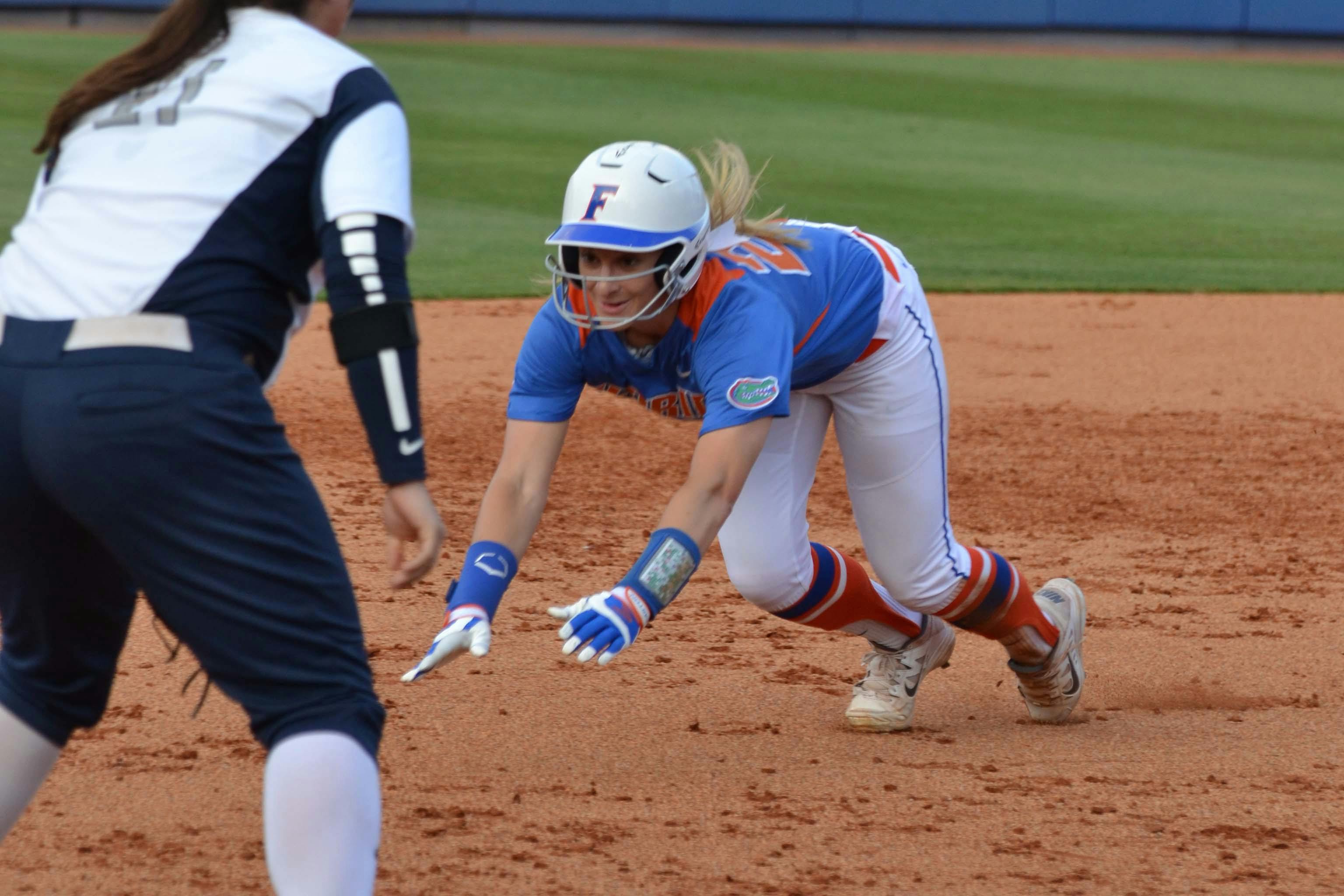 Kirsti Merritt smiles as she slides into third base during Florida's 2-1 win against North Florida on April 1, 2015, at Katie Seashole Pressly Stadium.