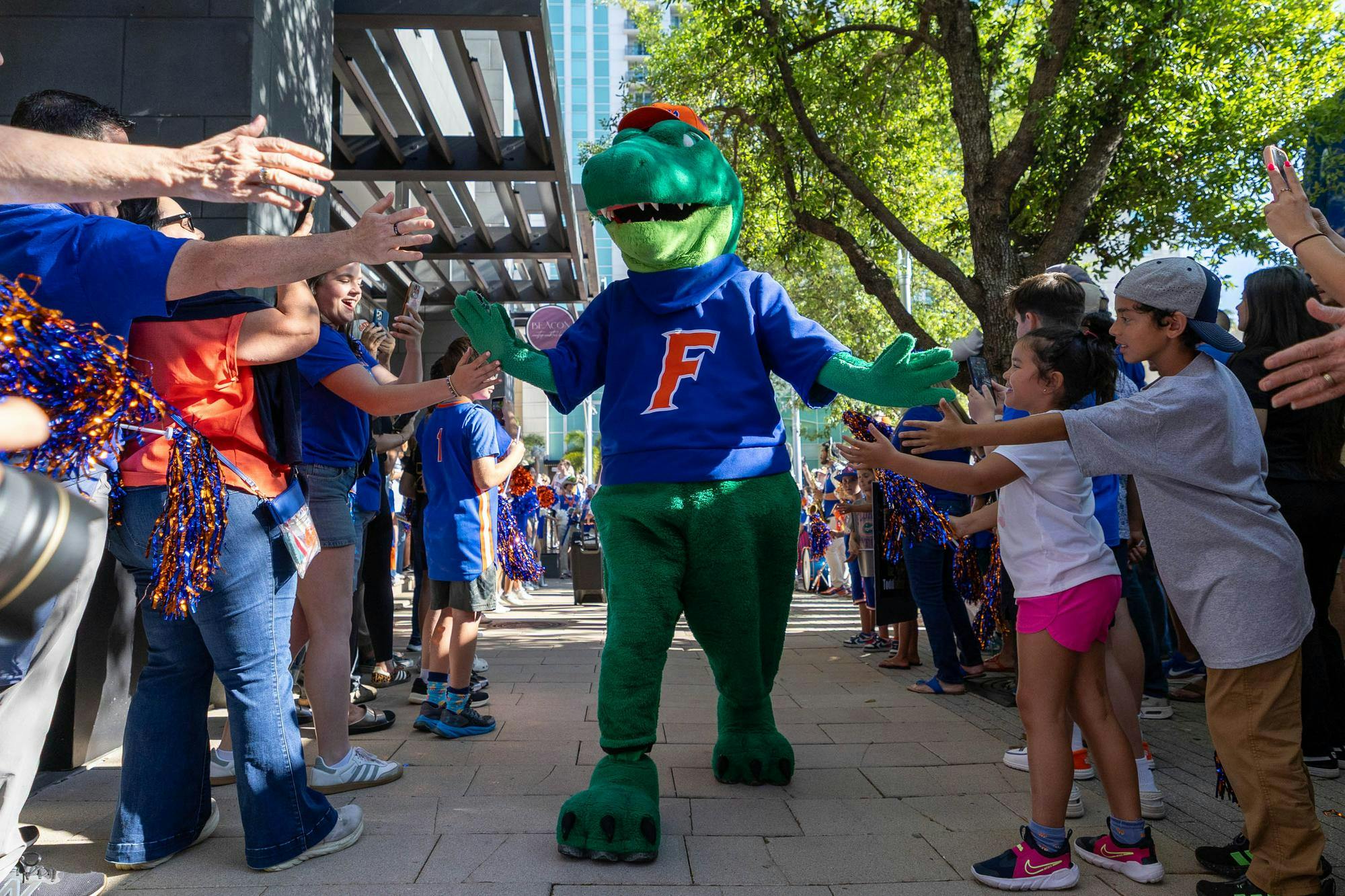 Albert the Gator walks through GatorWalk, Sunday, March 22, 2026, in front of the JW Marriott, in Tampa, Fla.