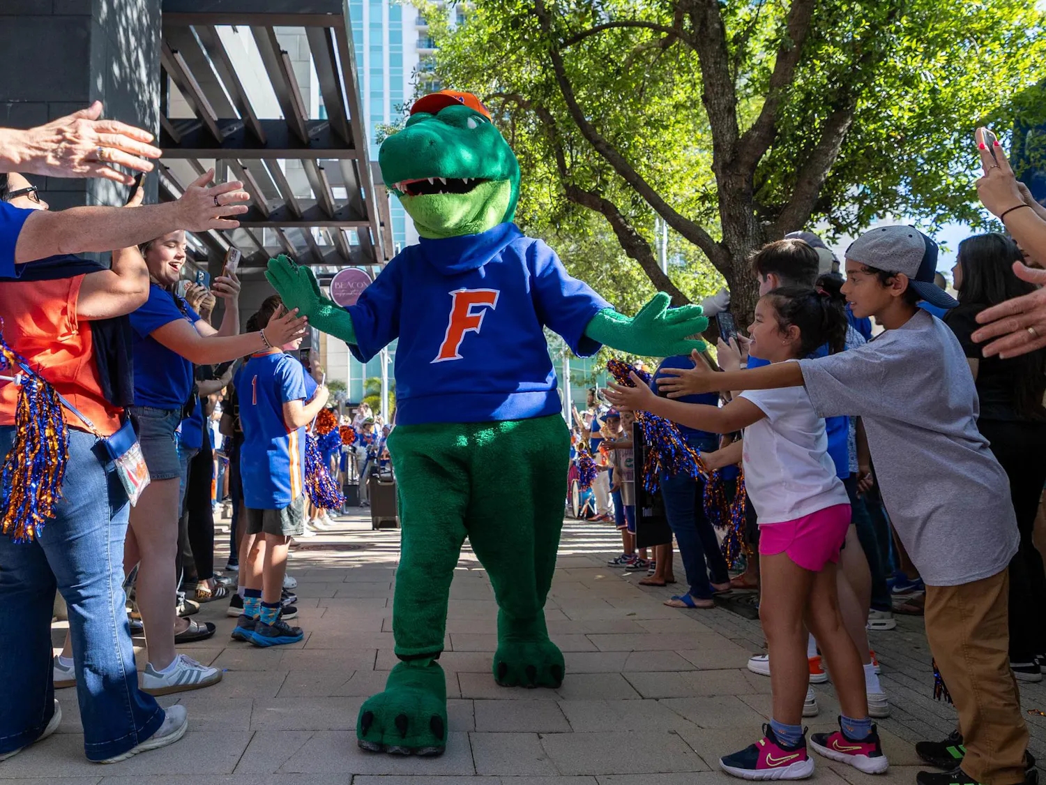 Albert the Gator walks through GatorWalk, Sunday, March 22, 2026, in front of the JW Marriott, in Tampa, Fla.