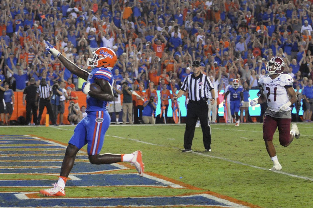 <p>UF tight end C'yontai Lewis celebrates as he scores a touchdown during Florida's 61-13 win against New Mexico State on Saturday at Ben Hill Griffin Stadium.</p>
