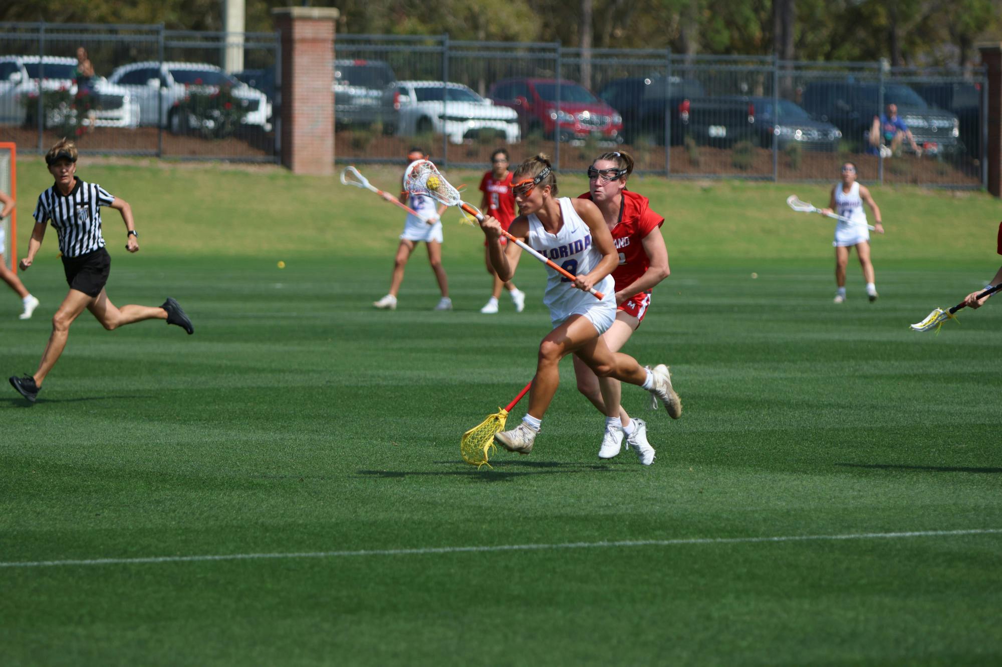 Florida midfielder Emily Heller carries the ball in her crosse in the Gators' 14-13 loss to the Maryland Terrapins Saturday, Feb. 25, 2023.