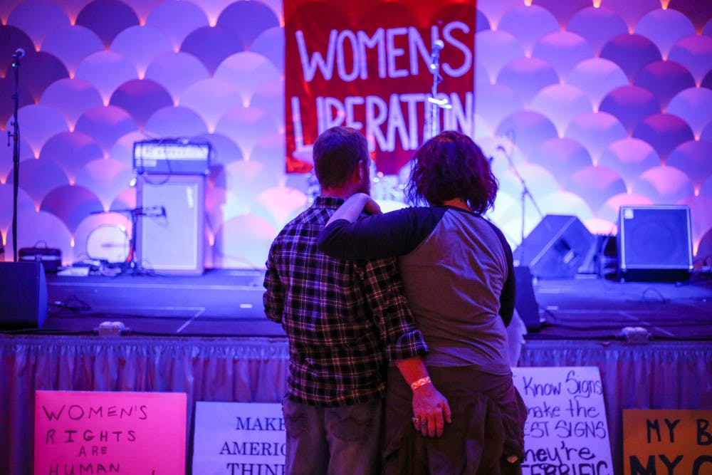 From left: 37-year-old Get Barber accompanies his girlfriend, 29-year-old Laurel Huntoon, to the Fourth Annual Roe v. Wade Anniversary Show, where the bands The Howleez, Bite Marks, The Ones to Blame, Endless Pools and Guts! performed. "I love the bands," Huntoon said. 