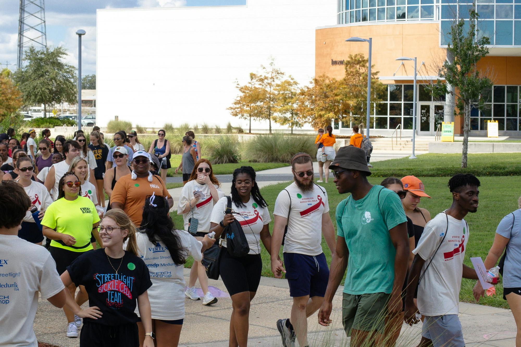 Participants at the Walk for Sickle Cell event grab drinks from volunteers at the finish line on Saturday, Sept. 21, 2024.