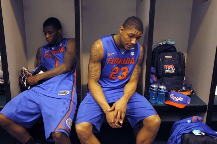 Florida's Bradley Beal (23) and Kenny Boynton sit in the locker room following their 72-68 loss to Louisville in an NCAA tournament West Regional final college basketball game, Saturday, March 24, 2012, in Phoenix. (AP Photo/Chris Carlson)