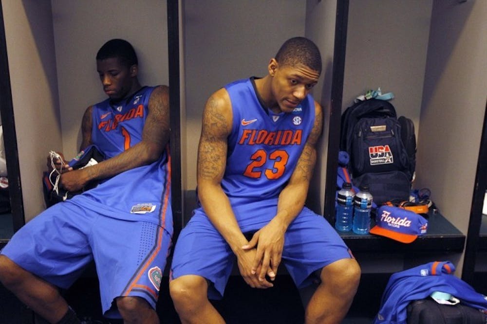 <p>Florida's Bradley Beal (23) and Kenny Boynton sit in the locker room following their 72-68 loss to Louisville in an NCAA tournament West Regional final college basketball game, Saturday, March 24, 2012, in Phoenix. (AP Photo/Chris Carlson)</p>