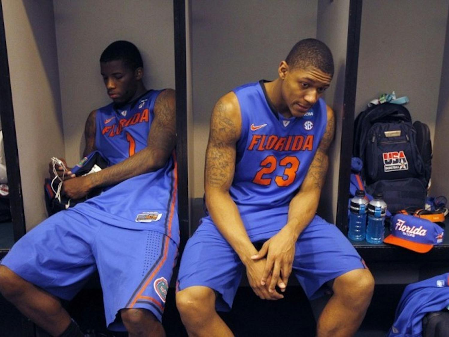 Florida's Bradley Beal (23) and Kenny Boynton sit in the locker room following their 72-68 loss to Louisville in an NCAA tournament West Regional final college basketball game, Saturday, March 24, 2012, in Phoenix. (AP Photo/Chris Carlson)