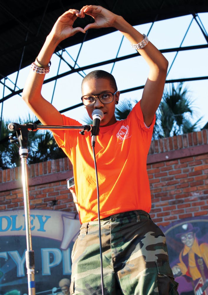 Joie, a 20-year-old artist, sings “Love Me Like I Do” to a crowd of about 300 at the Unite Against Bullying rally Wednesday evening.