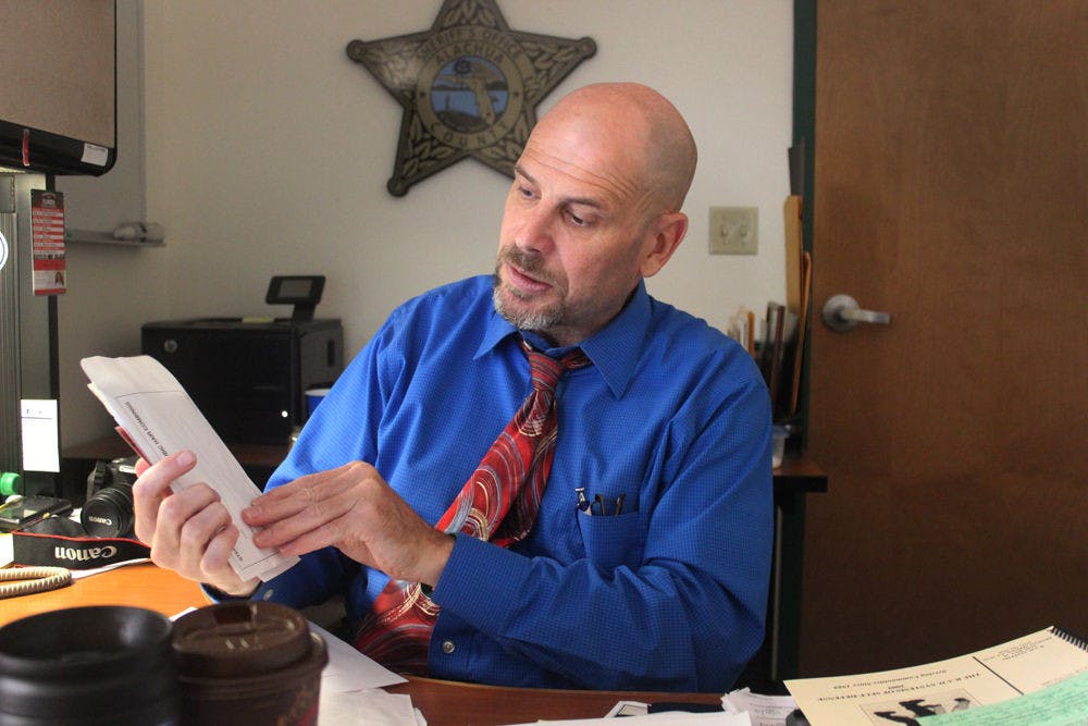 <p>Art Forgey, the spokesman for the Alachua County Sheriff’s Office, goes through a sample sexual assault evidence kit in his office Sept. 16, 2015. ACSO is looking to use DNA from rape kits and other cases to solve cold cases. “Twenty years from now, who knows what we’ll be able to do,” he said.</p>