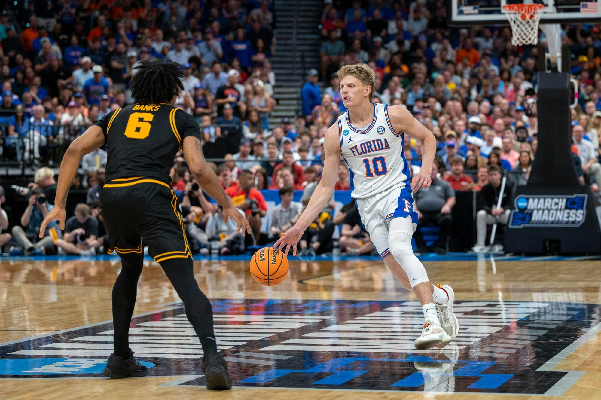 Florida forward Thomas Haugh (10) dribbles down the court  during the second half of an NCAA Tournament second round game against Iowa, Sunday, March 22, 2026, in Tampa, Fla.