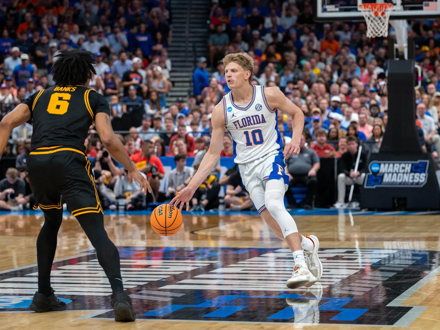 Florida forward Thomas Haugh (10) dribbles down the court during the second half of an NCAA Tournament second round game against Iowa, Sunday, March 22, 2026, in Tampa, Fla.