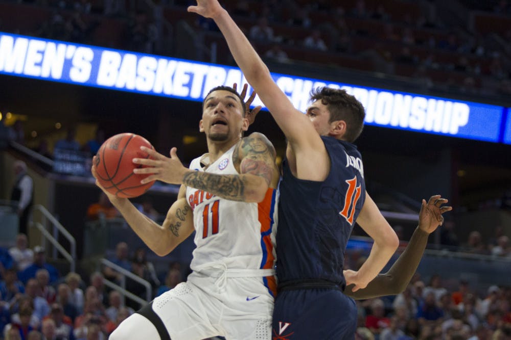 <p>Point guard Chris Chiozza shoots a contested layup in Florida's 65-39 win over Virginia in the Round of 32 in the NCAA Tournament on Saturday in Orlando. </p>