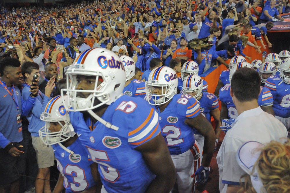 <p>UF football players run out of the tunnel prior to Florida's 27-2 loss to Florida State on Nov. 28, 2015, at Ben Hill Griffin Stadium.</p>