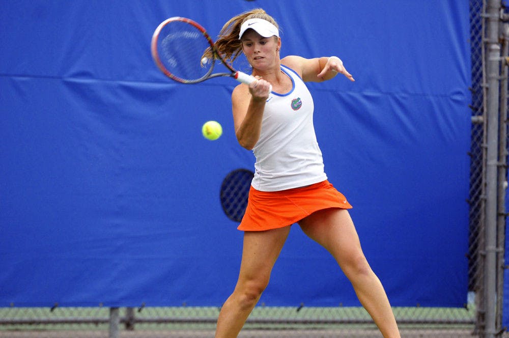 <p>UF's Belinda Woolcock returns the ball with a forehand during Florida's 6-1 win over USF on Jan. 21, 2016, at the Ring Tennis Complex.</p>