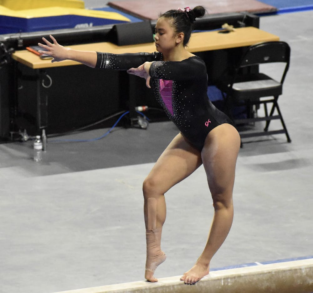 <p>Freshman Ellie Lazzari performs a routine on the balance bar on Feb. 19 against Kentucky. She was nearly perfect on Friday against Auburn as she posted a 9.975.</p>