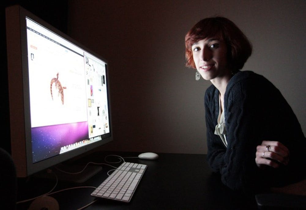 <p>Krissy Wilson, 22, poses for a photo at her computer Thursday.</p>