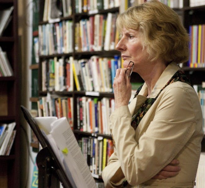Civic Media Center board member Paula Stahmer talks to Gainesville residents Tuesday evening about a controversial power plant project.
