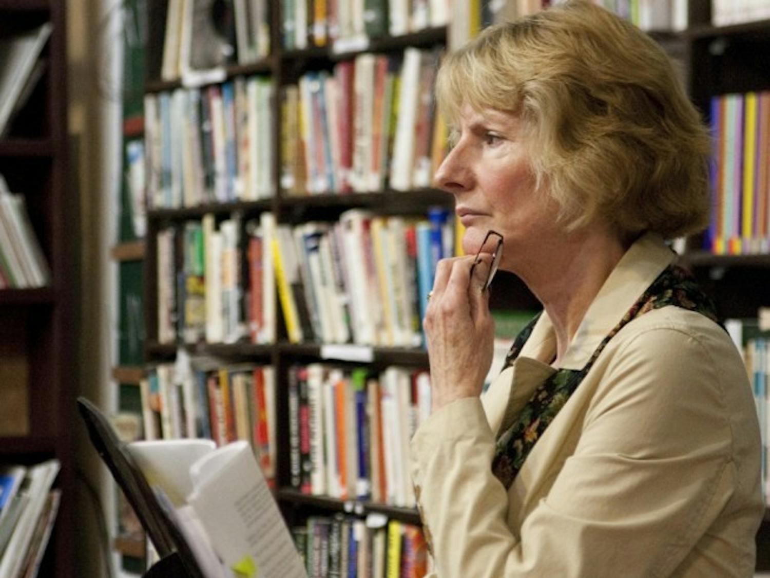 Civic Media Center board member Paula Stahmer talks to Gainesville residents Tuesday evening about a controversial power plant project.