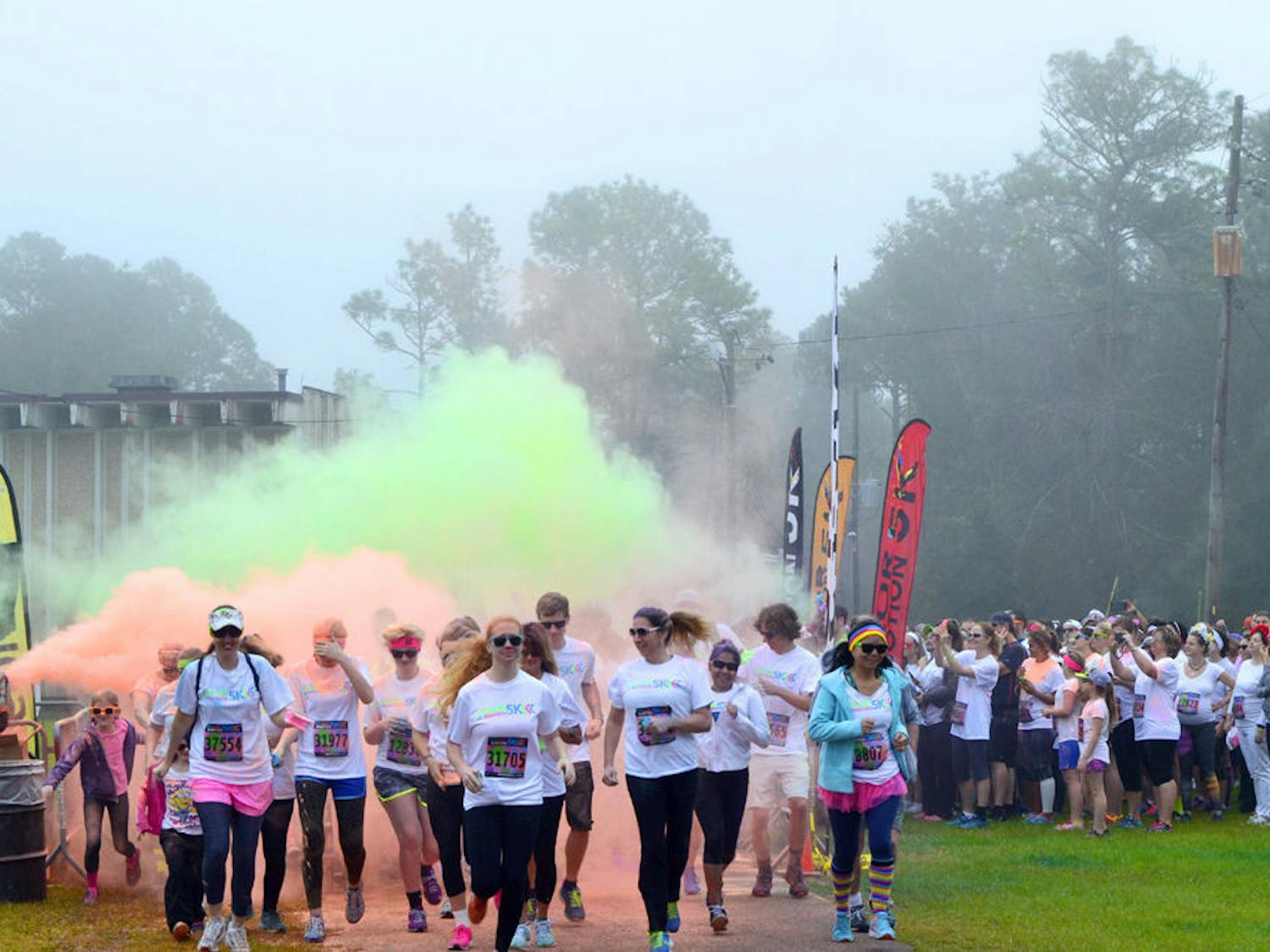 The second wave of runenrs take off from the starting line on Jan. 16, 2016, at the Alachua County Fairgrounds during the Color In Motion 5K run.