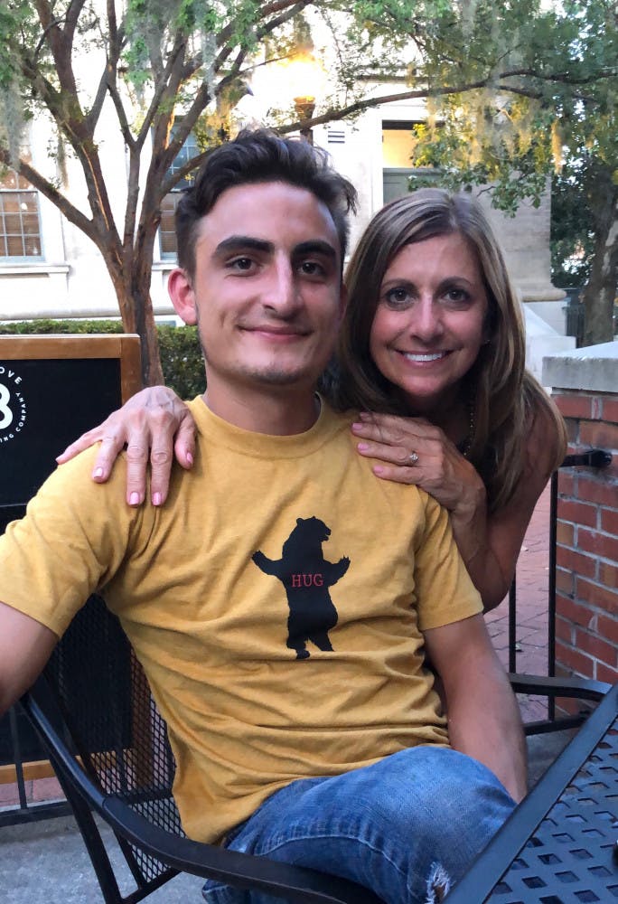 Mitch Capps, a 22-year-old UF forest resources and conservation junior, poses with his mom.   