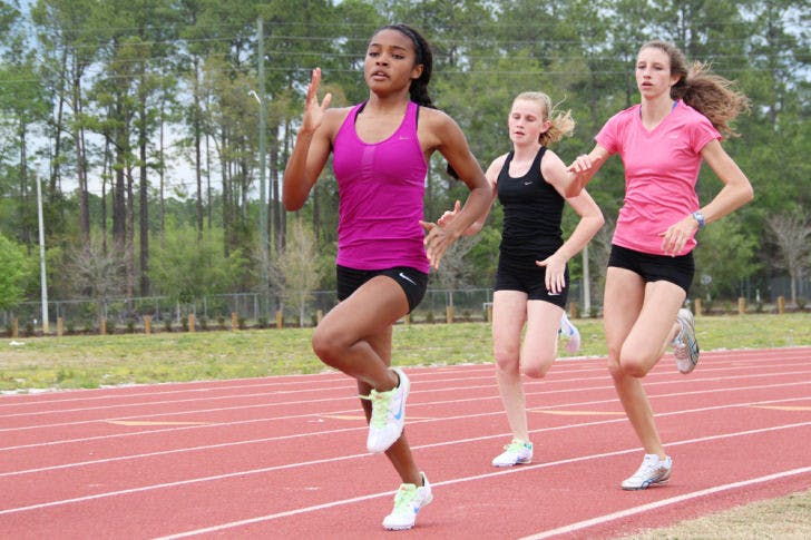 Three Eastside High School students run at Fred Cone Park, 2841 E. University Ave., during track practice on Monday afternoon.