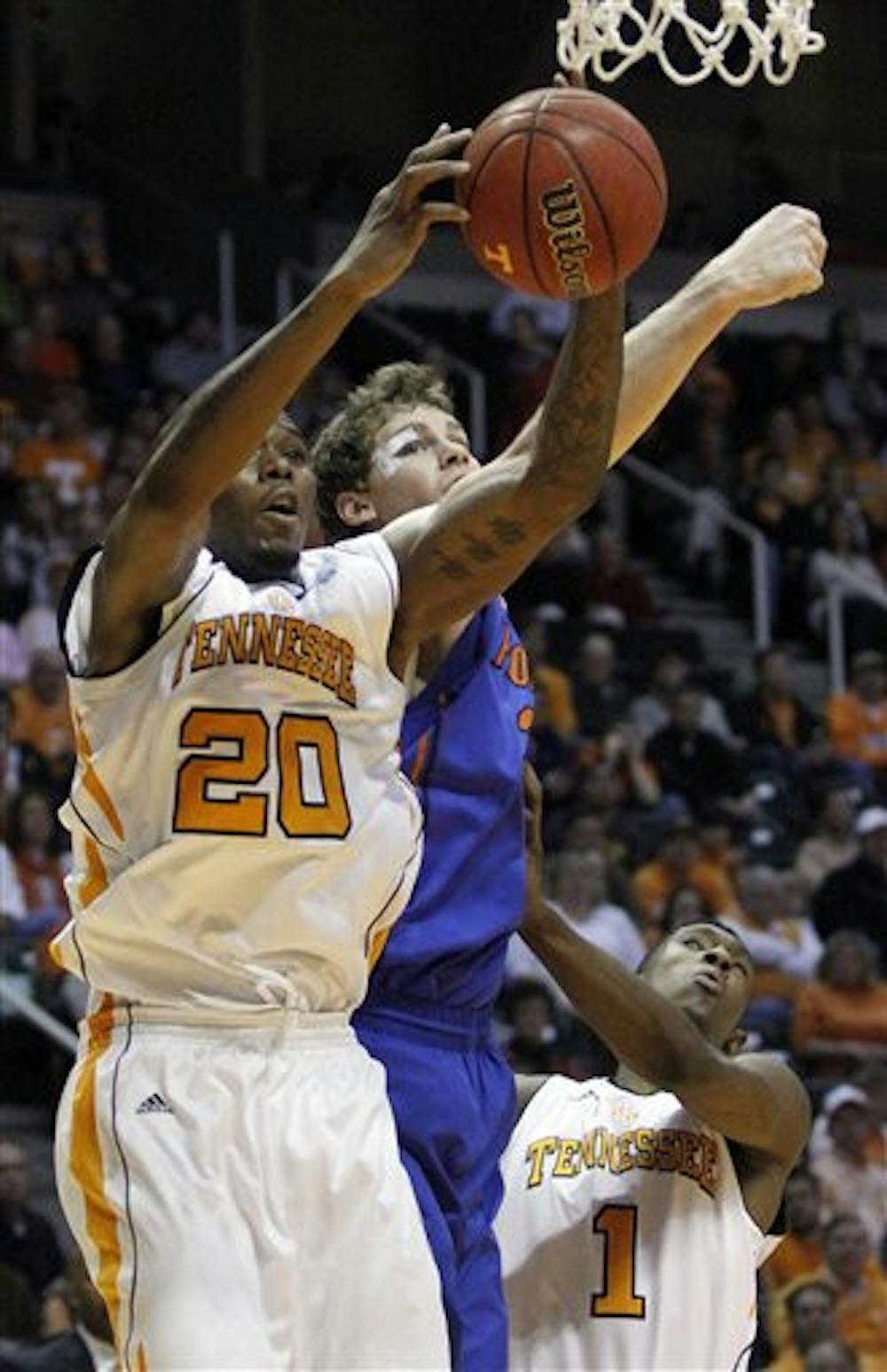 <p>Tennessee's Kenny Hall (20) grabs a rebound away from Florida's Erik Murphy in the first half of an NCAA college basketball game on Saturday, Jan. 7, 2012, in Knoxville, Tenn. Tennessee won 67-56. (AP Photo/Wade Payne)</p>
