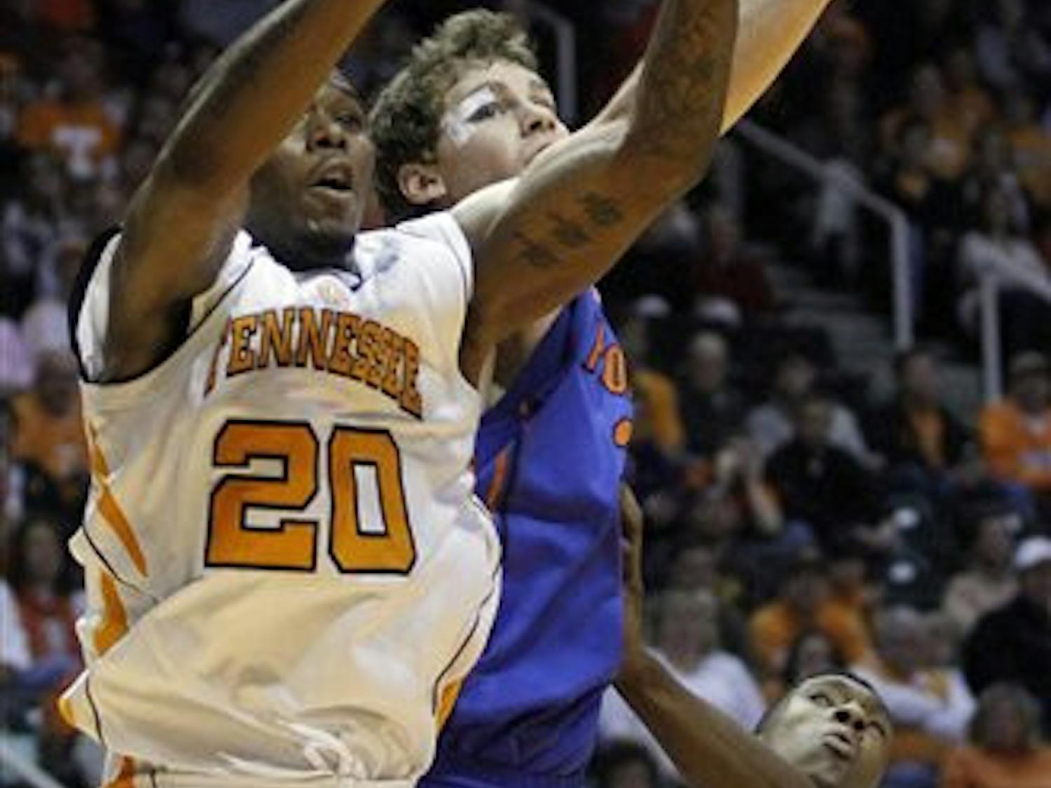 Tennessee's Kenny Hall (20) grabs a rebound away from Florida's Erik Murphy in the first half of an NCAA college basketball game on Saturday, Jan. 7, 2012, in Knoxville, Tenn. Tennessee won 67-56. (AP Photo/Wade Payne)