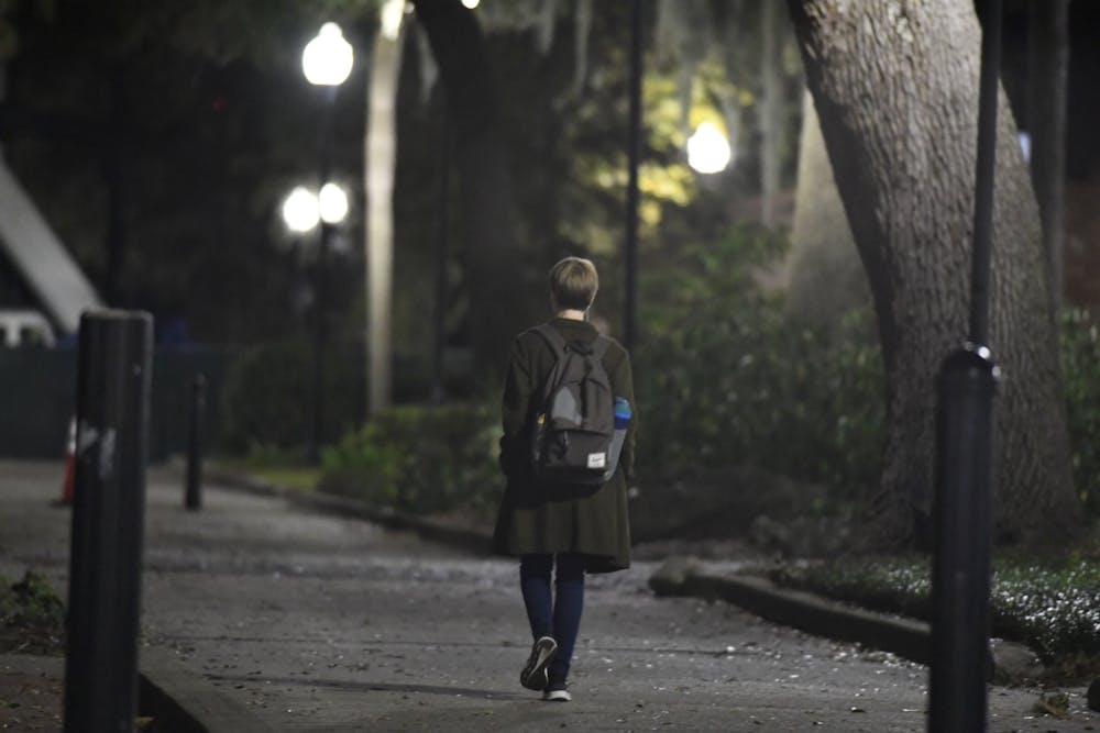 <p>UF student bundles up to walk across campus on Dec. 1, 2024.</p>