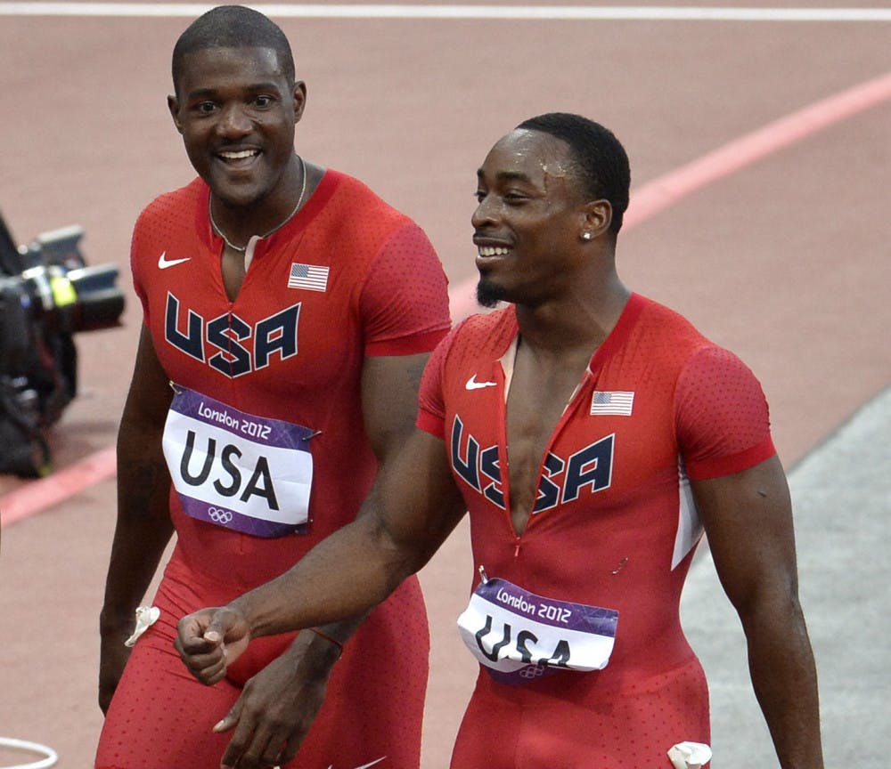 <p>Jeff Demps (right) smiles during the 2012 Summer Olympics in London, England.</p>
