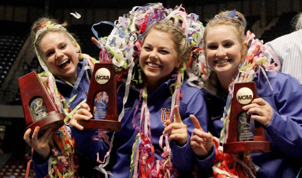 <p>Florida’s Bridgette Caquatto, Morgan Frazier and Claire Boyce celebrate after being crowned co-champions with Oklahoma during the NCAA Women’s Gymnastics Championships on Saturday in Birmingham, Ala.</p>