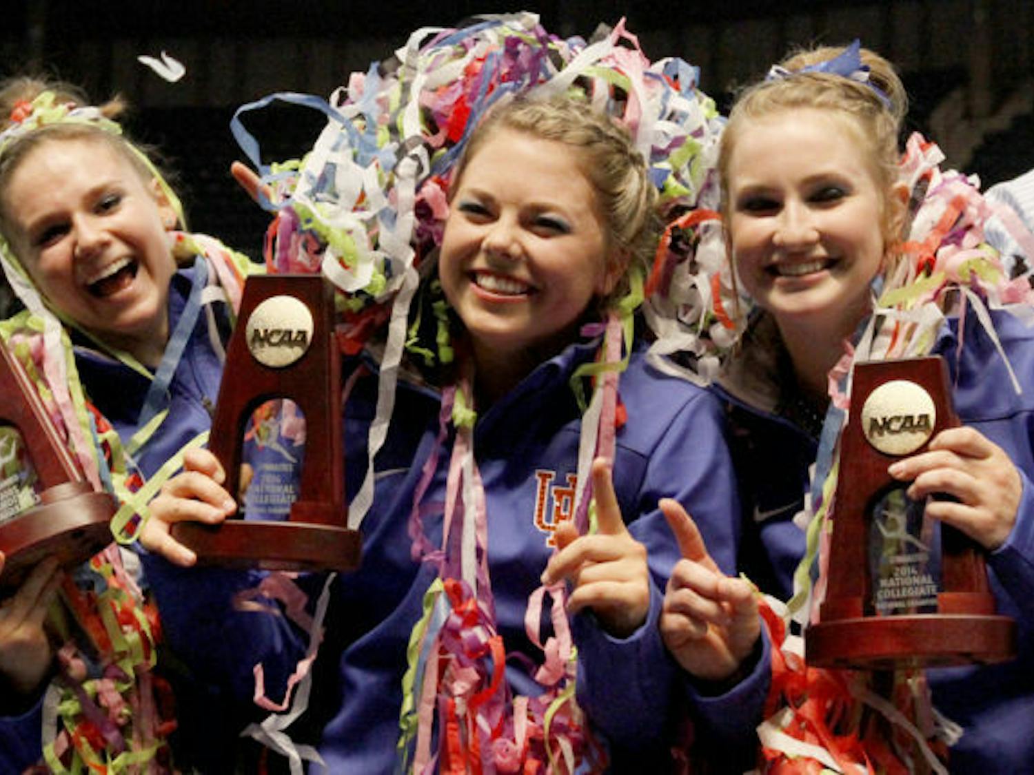 Florida’s Bridgette Caquatto, Morgan Frazier and Claire Boyce celebrate after being crowned co-champions with Oklahoma during the NCAA Women’s Gymnastics Championships on Saturday in Birmingham, Ala.
