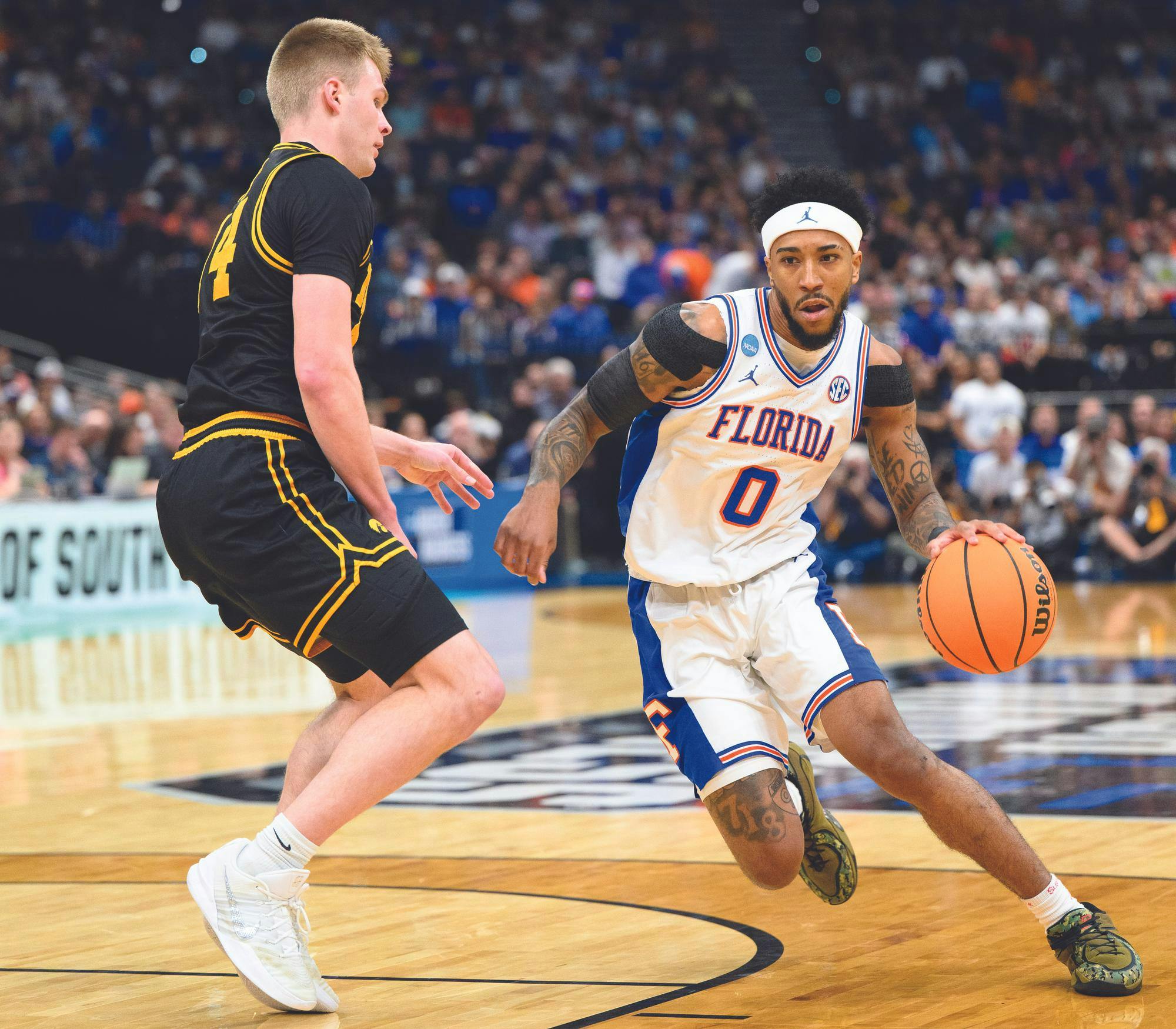 Florida guard Boogie Fland (0) drives against Iowa guard Bennett Stirtz (14) during the first half of an NCAA Tournament second round game against Iowa, Saturday, March 22, 2026, in Tampa, Fla.