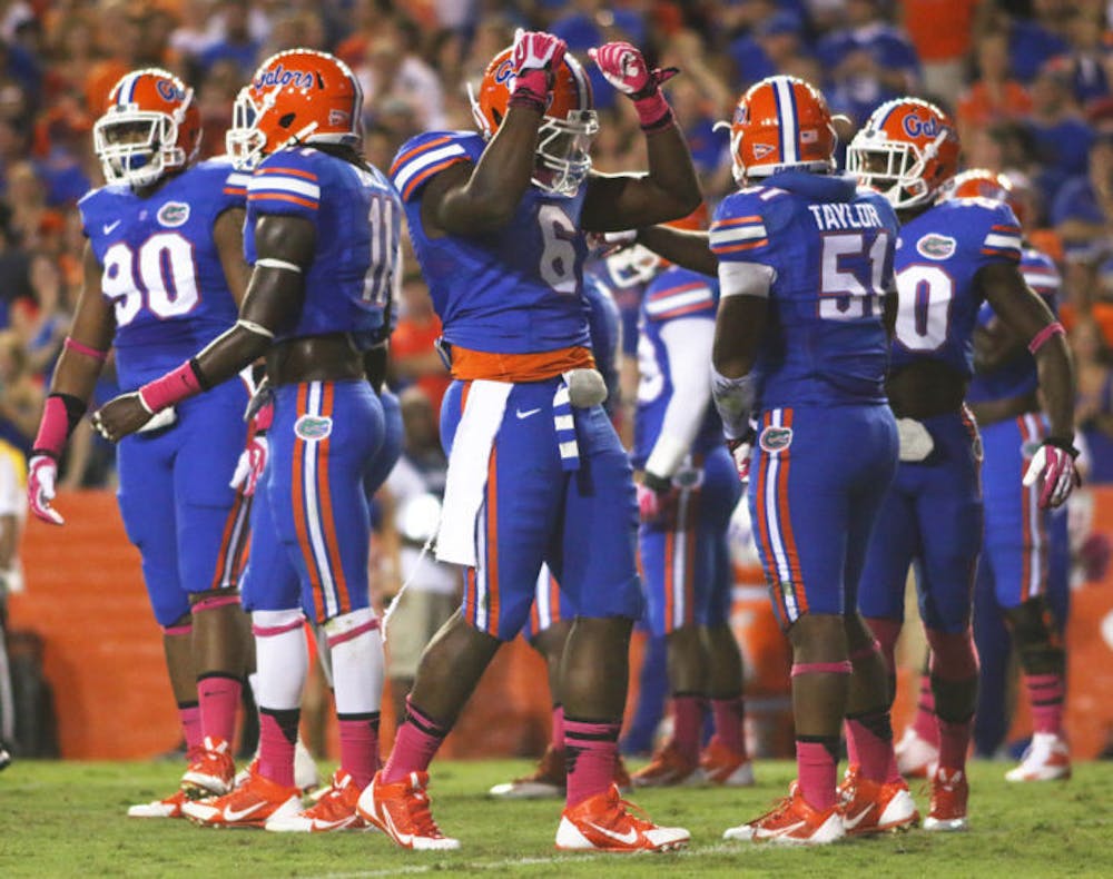 <p>Dante Fowler Jr. (6) celebrates after a play during Florida’s 30-10 victory against Arkansas on Saturday in Ben Hill Griffin Stadium. Fowler leads the Gators with three sacks and two forced fumbles in 2013.</p>