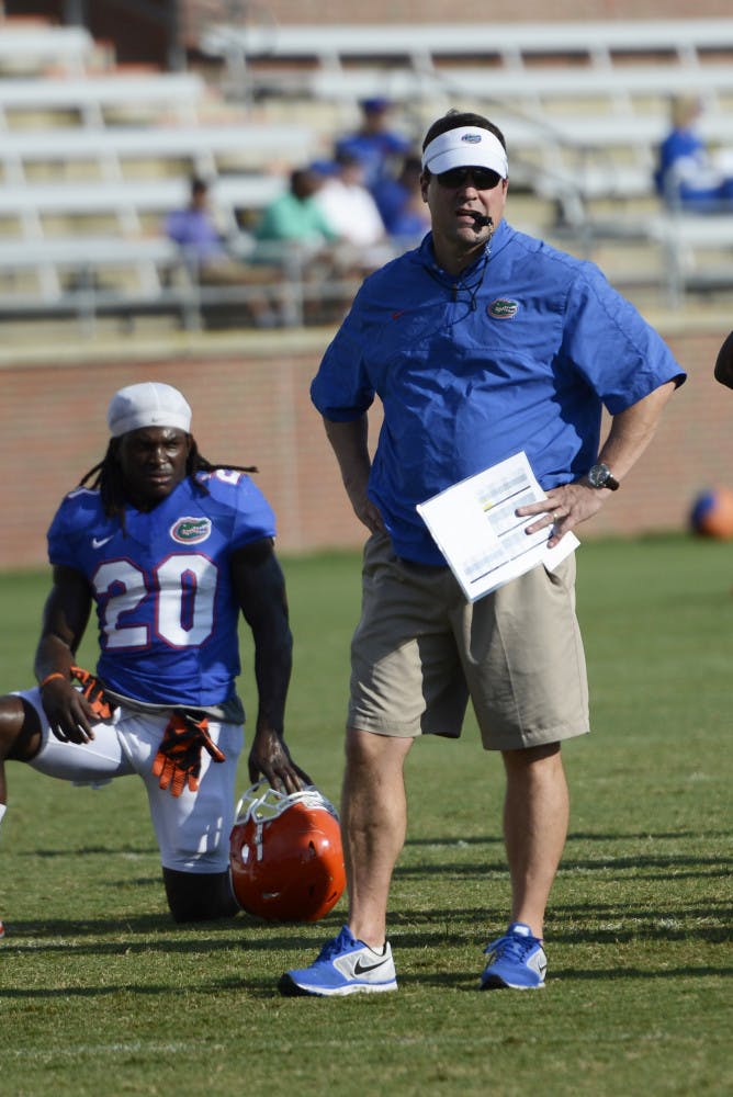 Coach Will Muschamp looks on during practice on Aug. 14 at Donald R. Dizney Stadium.
