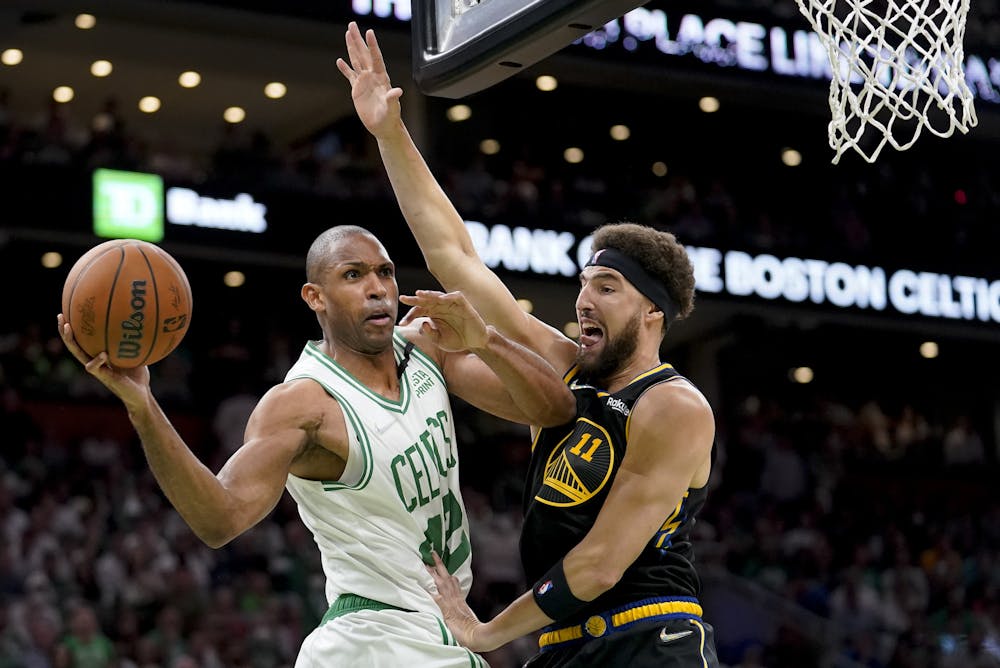 <p>Boston Celtics center Al Horford looks to pass against Golden State Warriors guard Klay Thompson during the second quarter of Game 4 of the NBA Finals, June 10, 2022. (AP Photo/Steven Senne)</p>